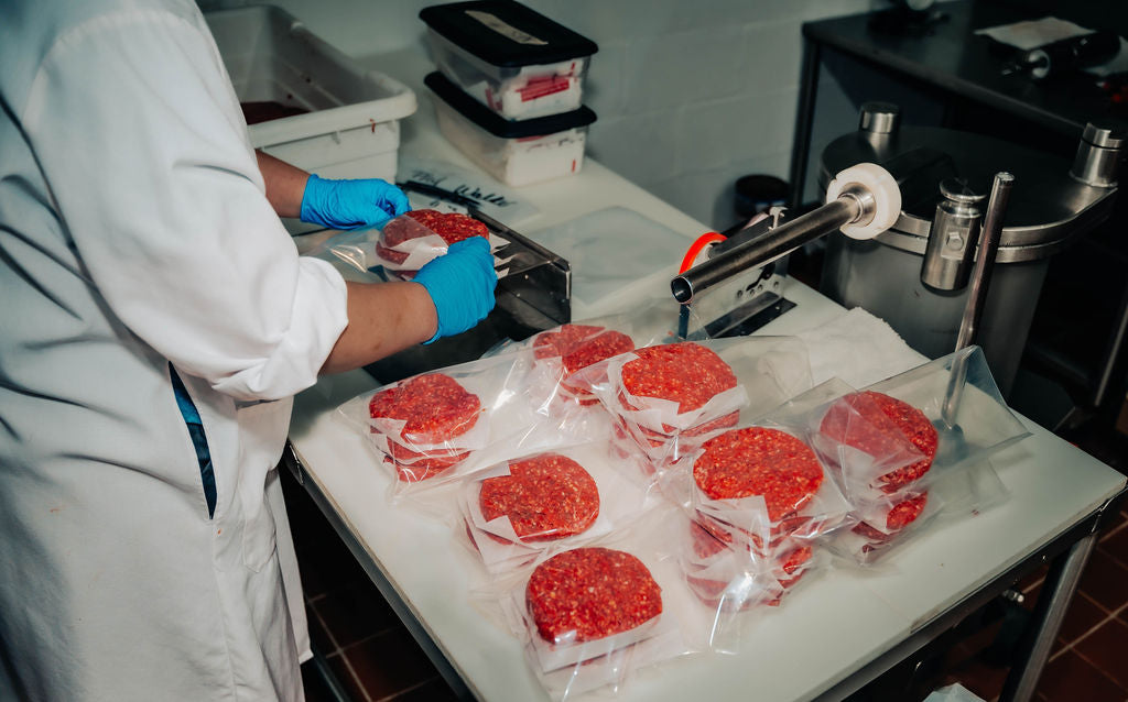 Packaging hamburger patties at WP Meat Co in Enfield, Illinois. 